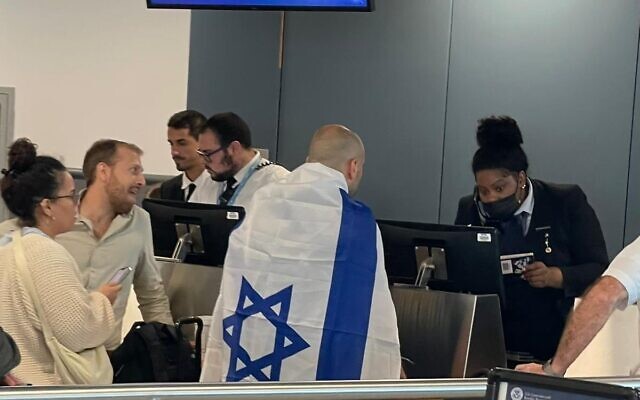 Israelis waiting at the gate at John F. Kennedy International Airport for an El Al flight to Israel on October 8, 2023 (Hillel Zand)