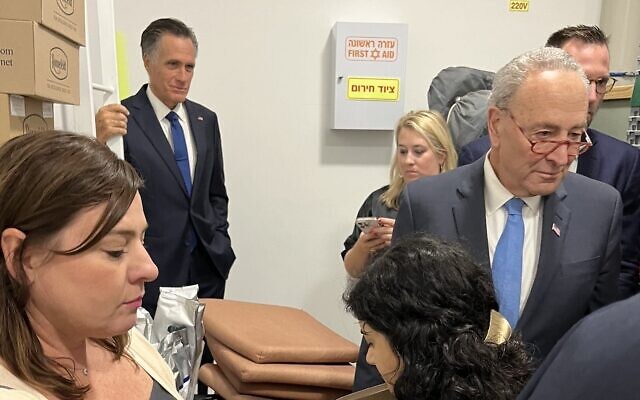 Senator Chuck Schumer, right, and Senator Mitt Romney, in back, shelter with aides in Tel Aviv during a rocket attack on October 15, 2023. (used in accordance with Clause 27a of the Copyright Law)