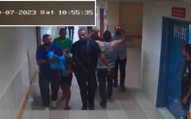 Hamas terrorists bring a hostage into Shifa Hospital as seen on surveillance footage from October 7, 2023. (IDF)