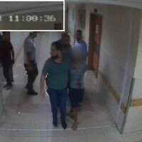 Hamas terrorists bring a hostage into Shifa Hospital as seen on surveillance footage from October 7, 2023. (IDF)