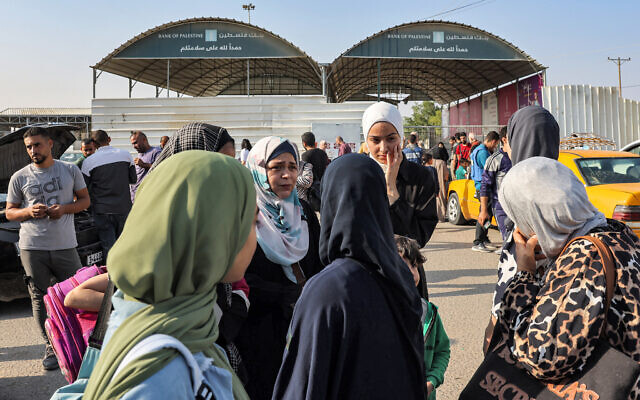 Travelers wait at the Rafah border crossing with Egypt in the southern Gaza Strip on November 1, 2023. (Mohammed ABED / AFP)