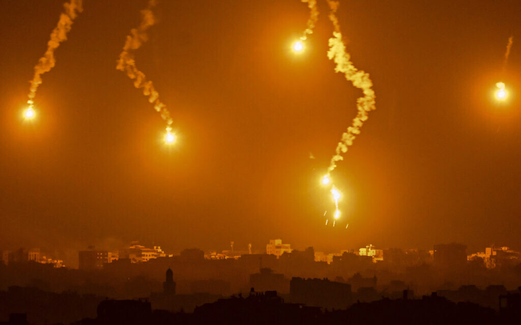 This picture taken from a position near Sderot along the Israeli border with the Gaza Strip on November 5, 2023, shows flares dropped by Israeli forces above the Palestinian enclave. (Aris MESSINIS / AFP)