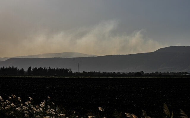 Illustrative: Smoke billows in the Upper Galilee after an exchange of fire between Israel and the Lebanese terror group Hezbollah, near Kibbutz Yiftah on Israel's border with Lebanon on November 5, 2023. (Jalaa Marey/AFP)