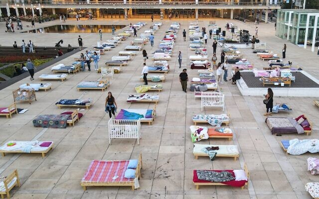 The 'Empty Beds' installation consisting of 241 beds representing the number of hostages taken by Hamas on October 7, at Habima Square in Tel Aviv on November 7, 2023. (Jack GUEZ / AFP)