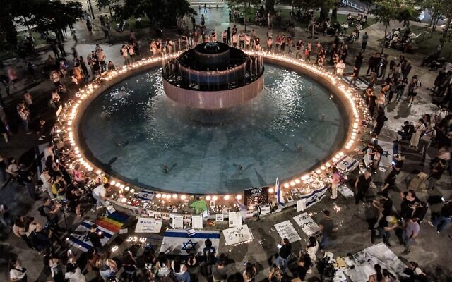 This aerial view shows people attending a candle-lit vigil for at Dizengoff Square in Tel Aviv on November 7, 2023, marking one month since the Hamas massacre. (Jack Guez/AFP)