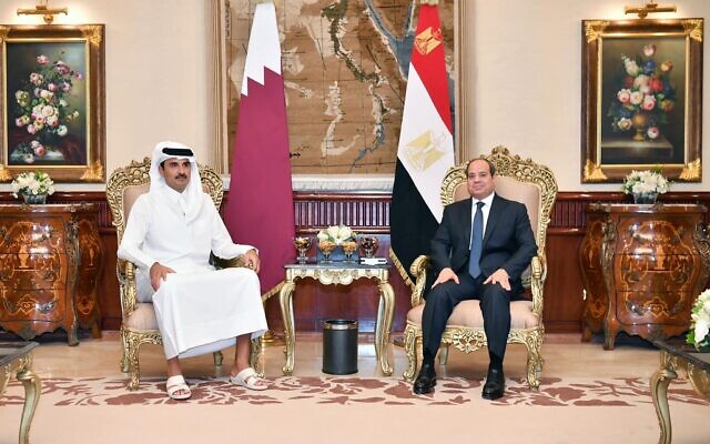This handout picture released by the Egyptian Presidency on November 10, 2023, shows Egypt's President Abdel Fatah al-Sisi (R) receiving Qatar's Emir Sheikh Tamim bin Hamad al-Thani in the Presidential Hall at Cairo International Airport. (Photo by Handout / Egyptian Presidency / AFP)
