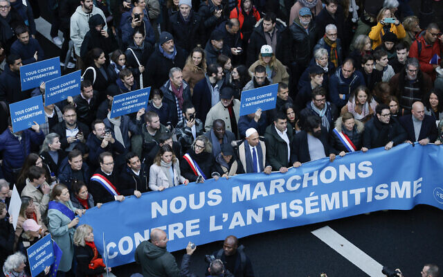 Polish-born French writer, artist and human rights activist Marek Halter (4thR) and officials march behing a banner which reads as "We march against antisemistim" in Paris on November 12, 2023. (Geoffroy Van der Hasselt / AFP)