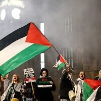 Protesters hold placards and flags and chant slogans at a rally in support of Palestinians and against Israel, outside of the Houses of Parliament in central London on November 15, 2023. (Henry Nicholls/ AFP)