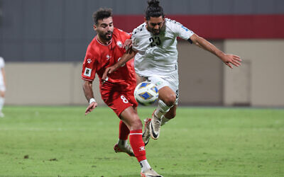 Palestinian national team's forward #23 Ataa Jaber fights for the ball with Lebanon's forward #08 Hassan Saad during the 2026 FIFA World Cup AFC qualifiers football match at the Khalid Bin Mohammed Stadium in Sharjah on November 16, 2023. (Photo by Giuseppe Cacace/AFP)
