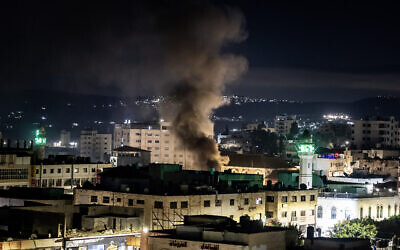 Smoke rises during an IDF raid in the West Bank Jenin refugee camp on November 16, 2023. (Fadel Senna / AFP)