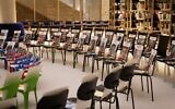 An installation consisting of chairs with books and portraits of Israeli hostages in Gaza seen at the new building of the National Library of Israel in Jerusalem, November 21, 2023. (Kenzo TRIBOUILLARD / AFP)