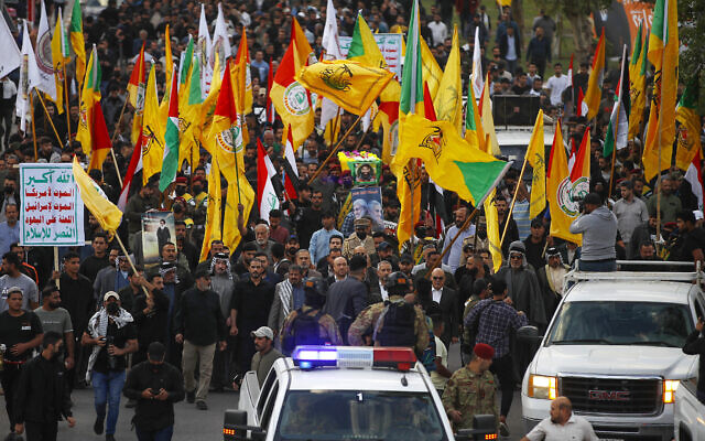 Iraqi mourners carry the coffin of Fadel al-Maksusi, a Kataeb Hezbollah fighter who was also part of the Islamic resistance in Iraq, the group that has claimed all recent attacks against US troops in Iraq and Syria, during a funeral in Baghdad on November 21, 2023. (Photo by AHMAD AL-RUBAYE / AFP)