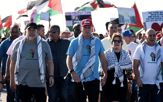 (L-R) Cuba's Prime Minister Manuel Marrero, Cuba's President Miguel Diaz-Canel, and his wife Lis Cuesta take part in a march in support of the Palestinian people and against Israel's war with Hamas in Havana, Cuba on November 23, 2023. (Yamil Lage/AFP)