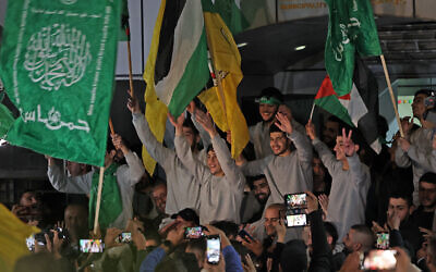 Released Palestinian security prisoners (wearing grey jumpers) cheer after being released from the Israeli Ofer military facility in Baytunia near the city of Ramallah in the West Bank in exchange for hostages freed by Hamas in Gaza, on November 24, 2023. (Photo by AHMAD GHARABLI / AFP)