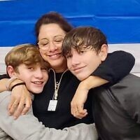 Renana Gome (middle) with her sons, Yagil Yaakov (left) and Or Yaakov, reunited after the boys' release on November 27, 2023 from Hamas captivity since October 7, 2023 (Courtesy)