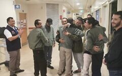Thai nationals freed from Gazan captivity hug at a hospital in Israel in a photo released by the Thai government on November 27, 2023. (Courtesy)