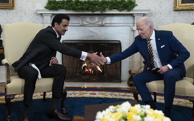 President Joe Biden, right, shakes hands with Qatar's Emir Sheikh Tamim bin Hamad Al Thani in the Oval Office of the White House, Jan. 31, 2022, in Washington. (AP Photo/Alex Brandon)