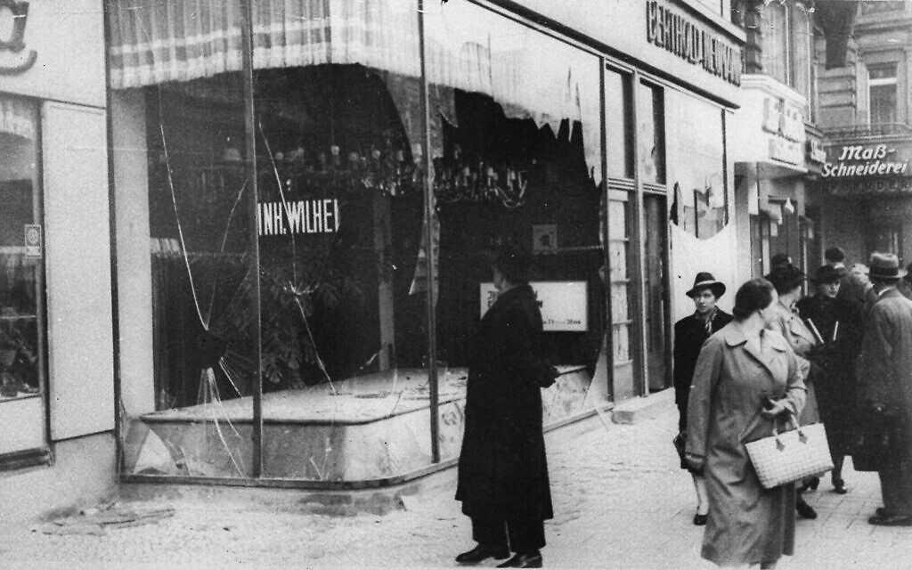 A man looks at the damage to a Jewish shop in Berlin on November 10, 1938, in the aftermath of Kristallnacht. (AP Photo/File)