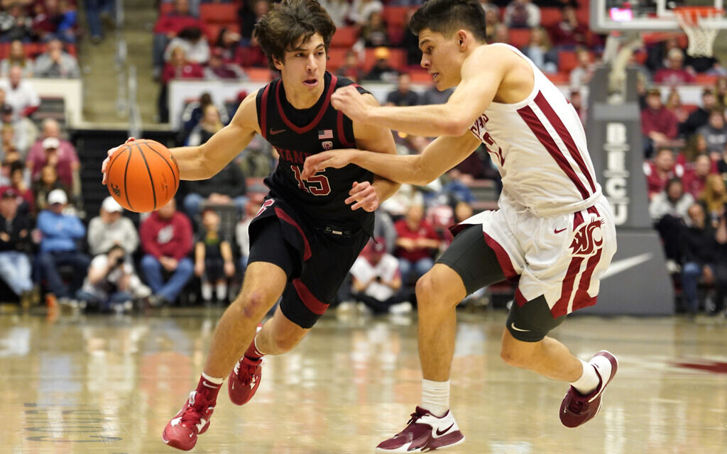 Stanford guard Benny Gealer (15) drives against Washington State guard Dylan Darling, right, during the second half of an NCAA college basketball game in Pullman, Washington, January 14, 2023. (AP Photo/ Dean Hare)
