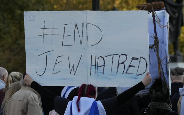 FILE - An Israeli supporter holds up a placard saying 'End Jew Hatred' as she takes part in a protest where placards with the faces and names of people believed taken hostage and held in Gaza were held up during a protest in Trafalgar Square, London, on October 22, 2023. (AP Photo/Frank Augstein, File)