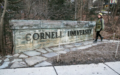 A woman walks by a Cornell University sign on the Ivy League school's campus in Ithaca, New York, on January 14, 2022. (Ted Shaffrey/AP)