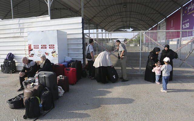 Palestinians wait at the border crossing between the Gaza Strip and Egypt, in Rafah, Nov. 1, 2023. (AP Photo/Hatem Ali)