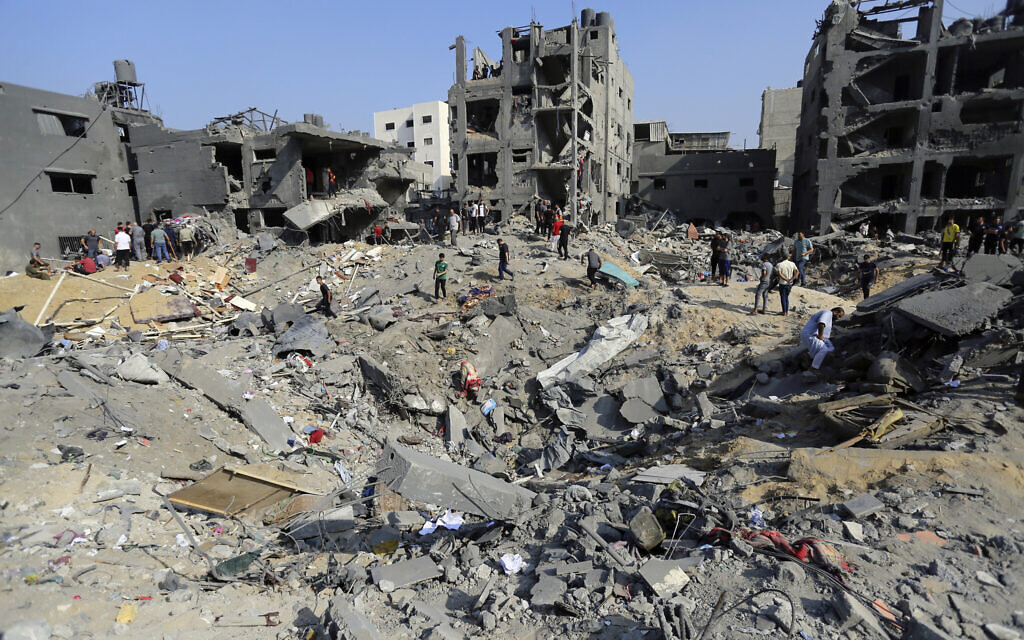 Palestinians wander among debris of buildings that Hamas says were targeted by Israeli airstrikes in Jabaliya refugee camp, northern Gaza Strip, November 1, 2023. The IDF has said it is targeting Hamas infrastructure above and below ground.  (Abed Khaled/AP)