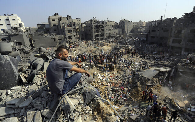 A man sits on the rubble overlooking the debris of buildings that were targeted by Israeli airstrikes in the Jabaliya refugee camp, northern Gaza Strip, Nov. 1, 2023. (AP Photo/Abed Khaled, File)