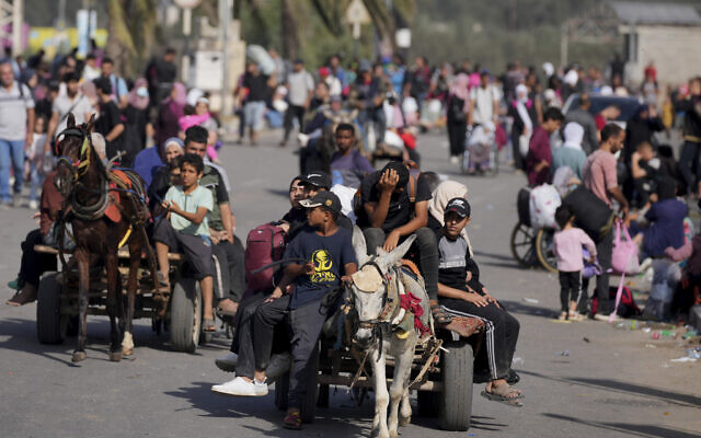 Palestinians flee to the southern Gaza Strip along Salah al-Din Street in Bureij, designated as a humanitarian corridor by the IDF to escape Gaza's north, November 9, 2023. (AP Photo/Hatem Moussa)