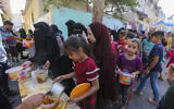 Palestinians line up for food in Rafah, southern Gaza Strip, November 8, 2023. (AP Photo/Hatem Ali)