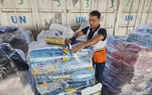 File: United Nations and Red Crescent workers prepare the aid for distribution to Palestinians at UNRWA warehouse in Deir Al-Balah, Gaza Strip, October 23, 2023. (AP Photo/Hassan Eslaiah)