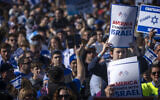 Young participants hold signs reading 'America Stands with Israel' as they take part in the March for Israel on the National Mall, November 14, 2023, in Washington, DC. (AP Photo/Mark Schiefelbein)