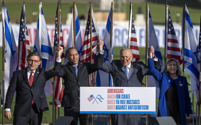 FILE - From left, Speaker of the House Mike Johnson., left, House Minority Leader Hakeem Jeffries, Senate Majority Leader Chuck Schumer, and Senator Joni Ernst, right, join hands at the March for Israel on November 14, 2023, on the National Mall in Washington. (AP Photo/Mark Schiefelbein)
