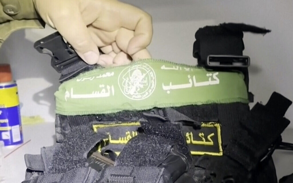 In this image taken from a video released by the Israeli Defense Forces, Nov. 15, 2023, Lt. Col. Jonathan Conricus, an Israeli military spokesman, holds up a bulletproof vest with a Hamas insignia that was found along with weapons the IDF says were in a medical closet at the MRI center at al-Shifa hospital in Gaza City. (Israel Defense Forces via AP)