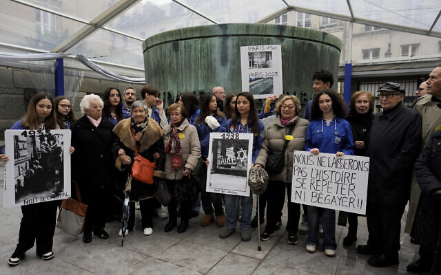 French Nazi hunter Serge Klarsfeld, right, his wife Beata, second from right, and French Holocaust survivors Edith Senot, third from left, and Ginette Kolinka, fifth from left, attend a gathering in the Paris Holocaust Memorial war of resurgent antisemitism linked to the 2023 Israel-Hamas war, in Paris, November 18, 2023. (AP Photo/Thibault Camus)