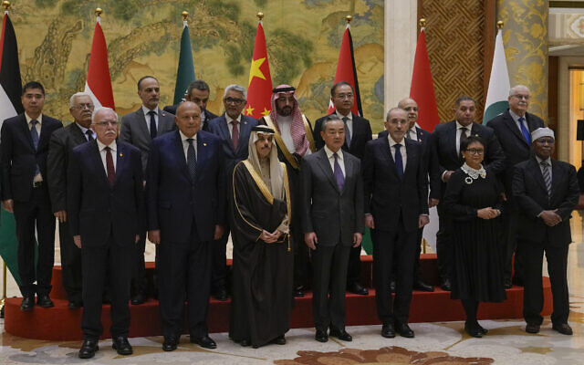 Chinese Foreign Minister Wang Yi, foreground center, stands with his counterparts from left, Palestinian Authority Foreign Minister Riyad al-Maliki, Egyptian Foreign Minister Sameh Shoukry, Saudi Arabia's Foreign Minister Faisal bin Farhan Al Saud, Jordanian Deputy Prime Minister and Foreign Minister Ayman Safadi, Indonesian Foreign Minister Retno Marsudi, Secretary-General of the Organization of Islamic Cooperation (OIC) Hissein Brahim Taha and their delegations as they pose for a group photo prior to their meeting at the Diaoyutai state guesthouse in Beijing, November 20, 2023. (Andy Wong/AP)