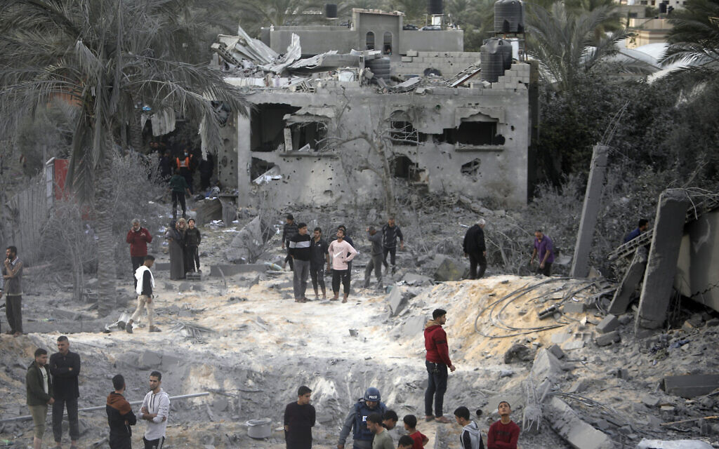 Palestinians inspect the damage of a destroyed house following Israeli airstrikes in the town of Khan Younis, southern Gaza Strip, Nov. 22, 2023. (AP Photo/Mohammed Dahman)
