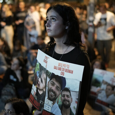 People participate in a show of solidarity with hostages being held in the Gaza Strip, near the Museum of Art in Tel Aviv, Israel, Saturday, Nov. 25, 2023. (AP Photo/ Leo Correa)