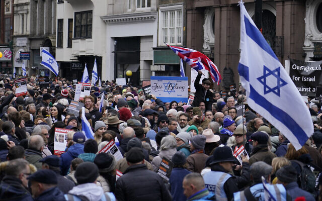 Protesters hold placards, flags and banners during a rally against antisemitism in London, Nov. 26, 2023. (AP Photo/Alberto Pezzali)