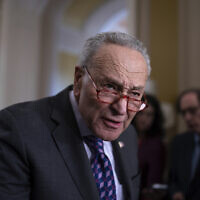 Senate Majority Leader Chuck Schumer answers questions from reporters outside the Senate chamber, at the Capitol in Washington, Nov. 28, 2023. (AP Photo/J. Scott Applewhite)