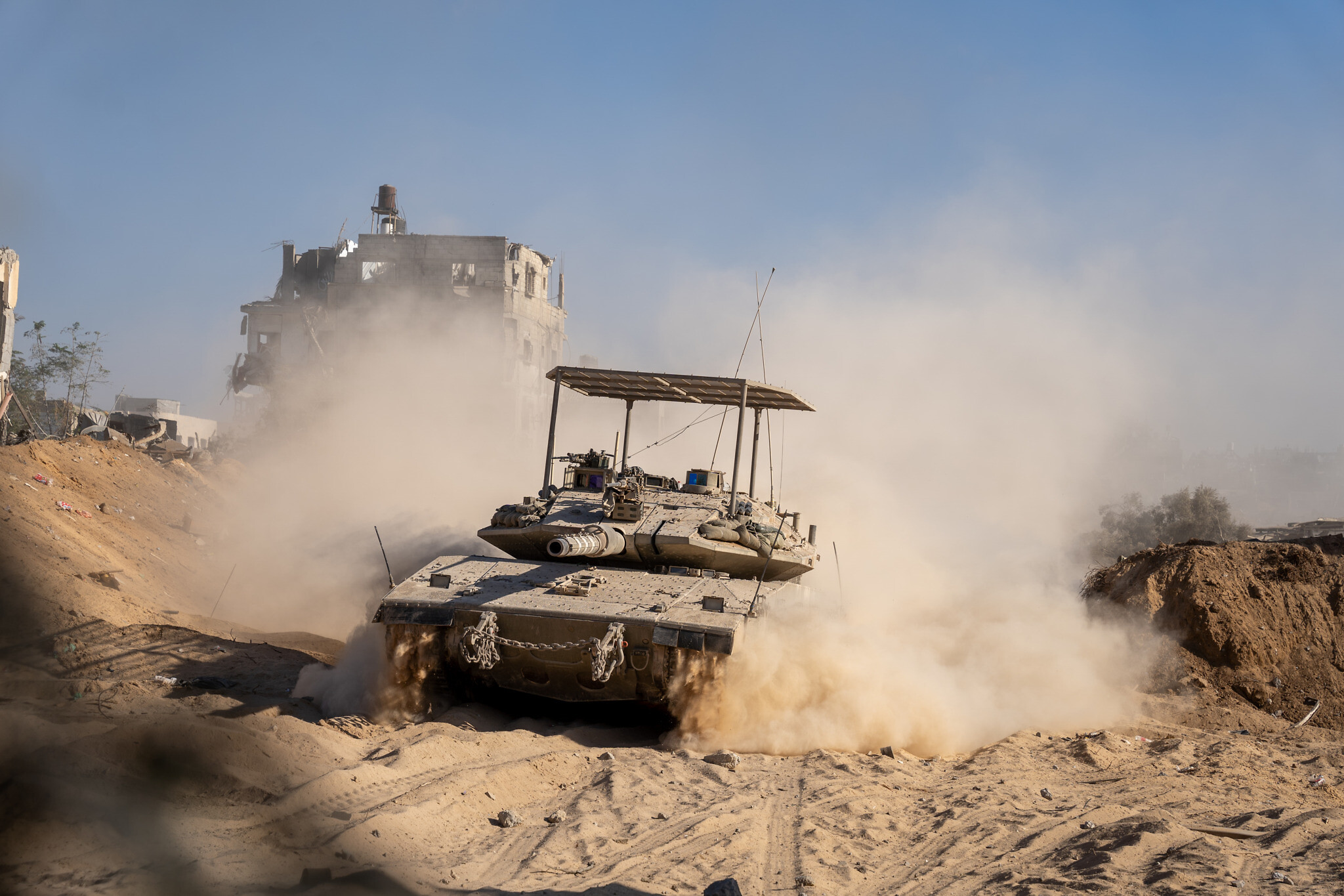An IDF Merkava tank drives in the northern Gaza Strip,  November 7, 2023. (Emanuel Fabian/Times of Israel)