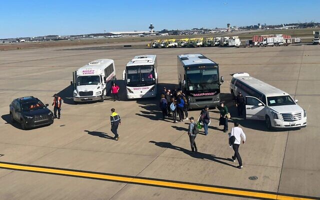 Makeshift buses, including a rented limousine, arrive to replace the ones hired by the Jewish Federation of Metropolitan Detroit, in this picture taken from a plane chartered by the federation to the March for Israel, Nov. 14, 2023. (Courtesy of Jennie Levy via JTA)
