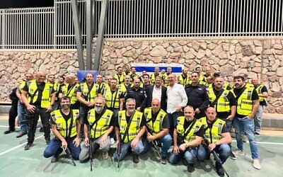 National Security Minister Itamar Ben Gvir poses with members of the civilian security squad in Eilat after handing them each weapons on November 15, 2023. (Itamar Ben Gvir/X)
