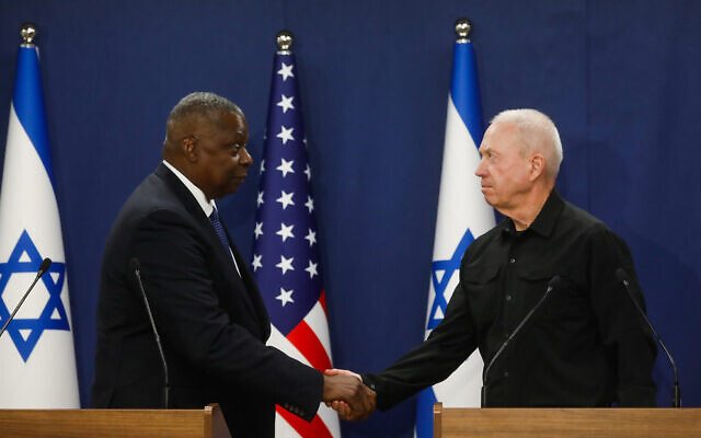 Defense Minister Yoav Gallant (R) and his US counterpart Lloyd Austin shake hands while delivering joint statements at the Kirya military base in Tel Aviv on October 13, 2023. (Miriam Alster/Flash90)