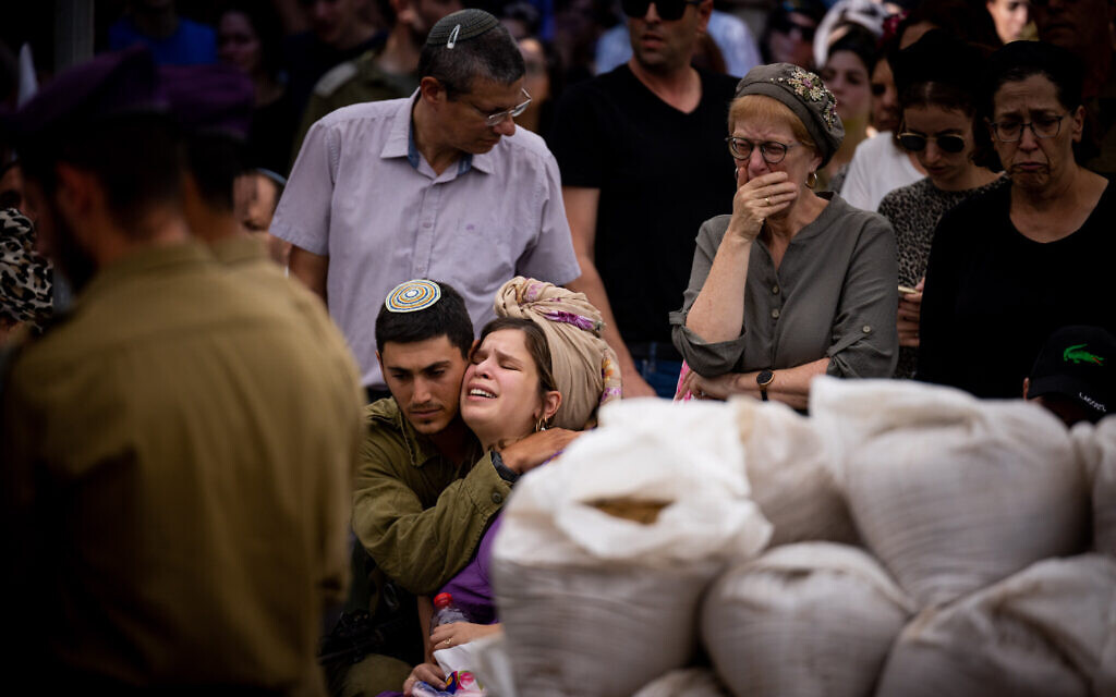 Family and friends of Staff Sgt. Yonadav Raz Levenstein, an IDF soldier killed in Gaza, mourn at his funeral at the Mount Herzl military cemetery in Jerusalem on November 5, 2023. (Yonatan Sindel/Flash90)