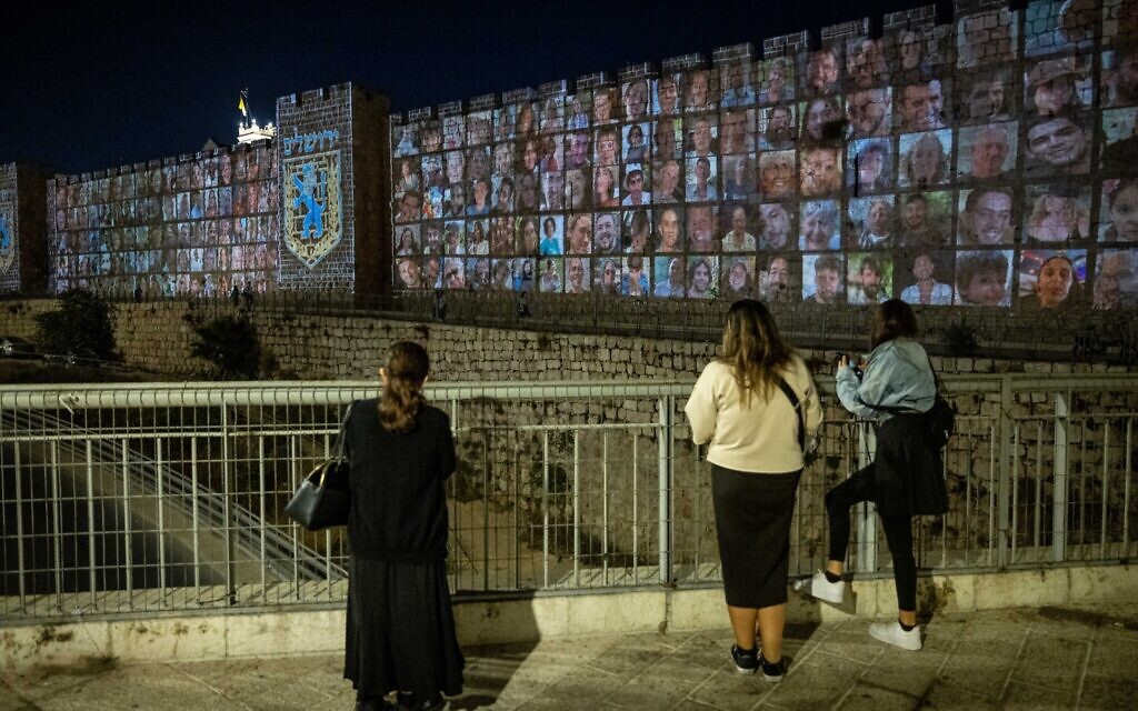 Pictures of Israelis abducted by Hamas terrorists in Gaza are screened on the walls of Jerusalem's Old City, on November 6, 2023. (Yonatan Sindel/Flash90)