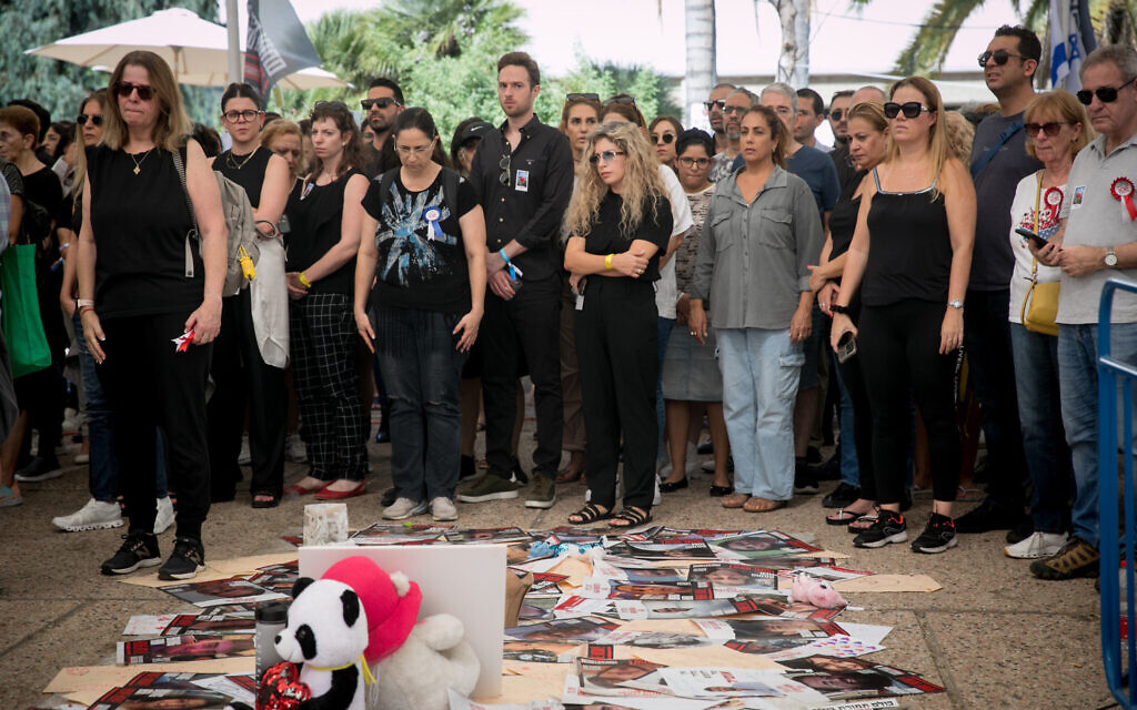 Israelis standing for a minute of silence for those killed and abducted by Hamas terrorists on October 7, at the "Hostages Square", outside the Ministry of Defense Headquarters in Tel Aviv on November 7, 2023. (Miriam Alster/Flash90)