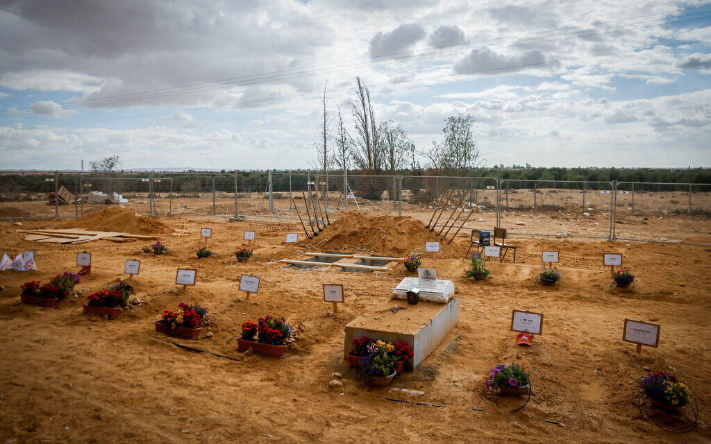 Graves of Kibbutz Be'eri residents who were murdered by Hamas terrorists on October 7, in Kibbutz Revivim, southern Israel, November 15, 2023 (Chaim Goldberg/Flash90)