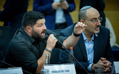 MK Almog Cohen of the far-right Otzma Yehudit party shouts at relatives of hostages held in Gaza during a hearing of the Knesset National Security Committee, November 20, 2023. (Yonatan Sindel/Flash90)