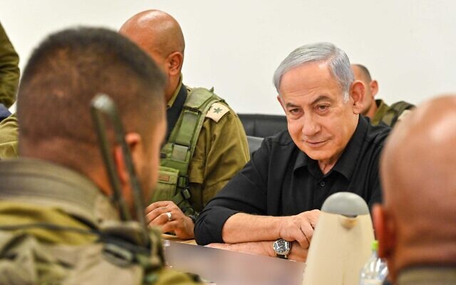 Prime Minister Benjamin Netanyahu, right, visits the IDF's Desert Reconnaissance Battalion, also known as Unit 585 or the Bedouin Battalion, on November 13, 2023. (Kobi Gideon/GPO)